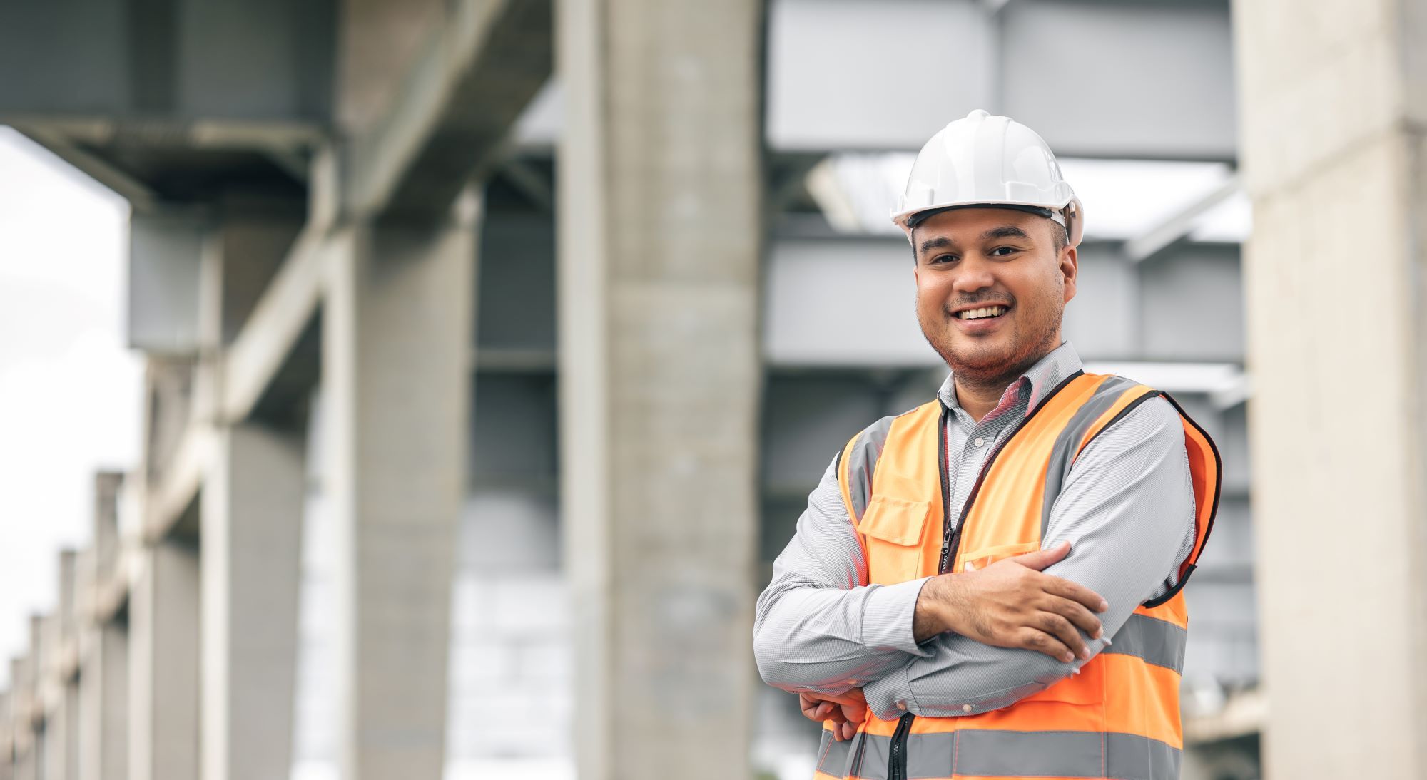 Smiling Man on Construction Site in hi-vis